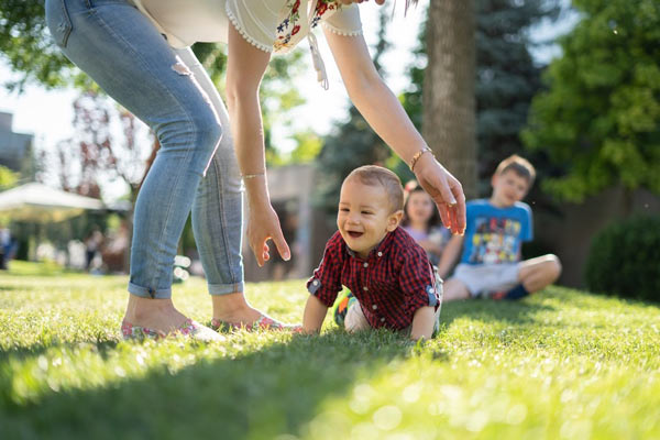 A mother playing with her child outside